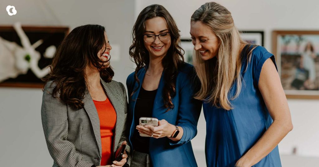 Small business owner using a smartphone with AI tools to generate creative ideas.